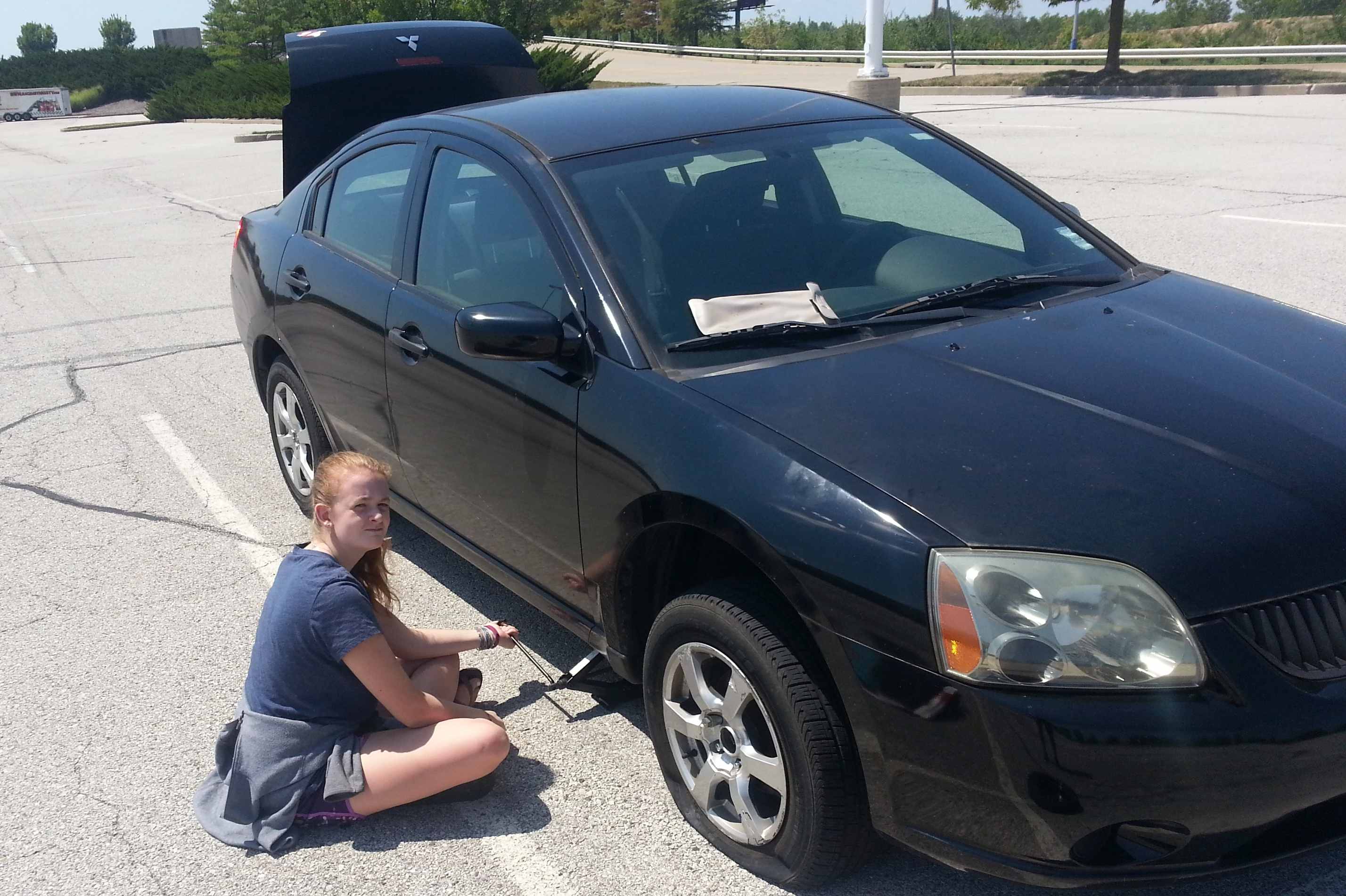2017-08-19 Jane chnages a tire.jpg